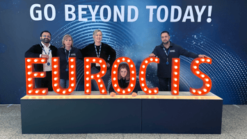 Count Matters team at EuroCIS 2025, posing with illuminated 'EUROCIS' letters against a backdrop that reads 'Go Beyond Today!